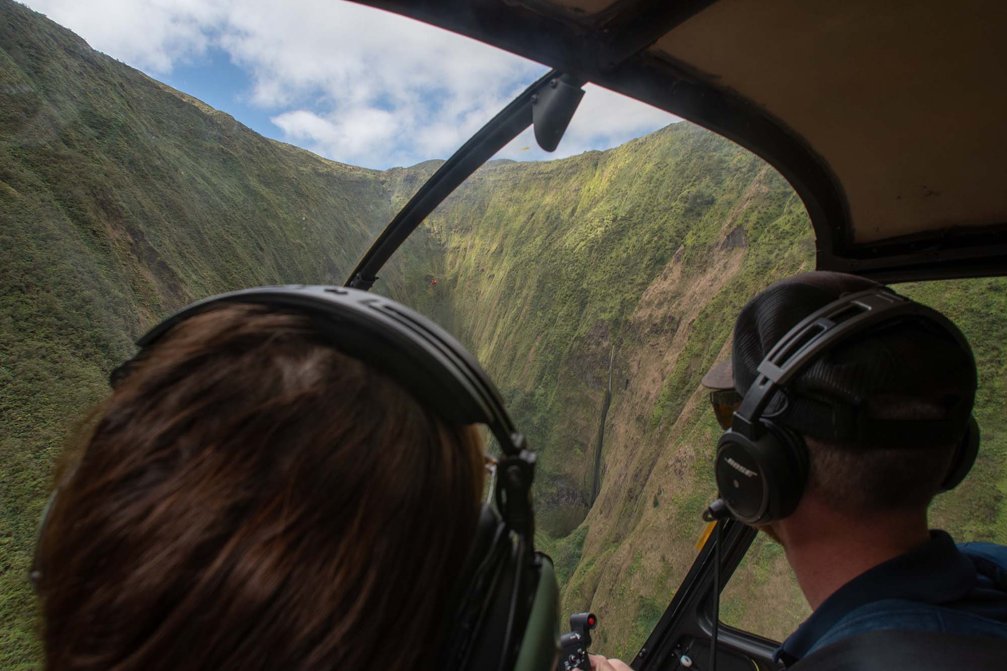 A helicopter flying in the mountains