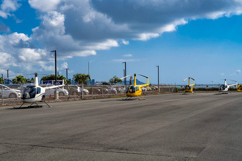 4 helicopters sit on a ramp